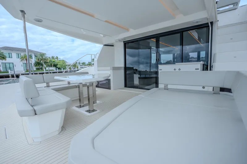 Althea Yacht Photos Pics Luxurious 2025 Leopard 53 Powercat yacht deck with modern seating and dining area.