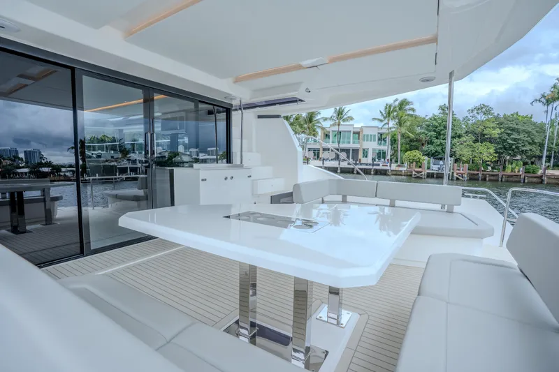 Althea Yacht Photos Pics Luxurious 2025 Leopard 53 Powercat yacht with elegant outdoor seating and dining area.