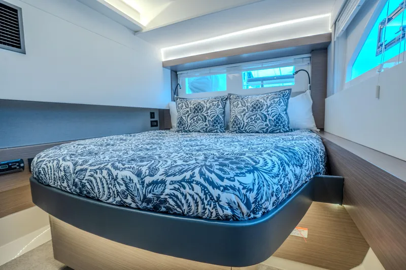 Althea Yacht Photos Pics Luxurious bedroom interior of 2025 Leopard 53 Powercat yacht with elegant bedding.