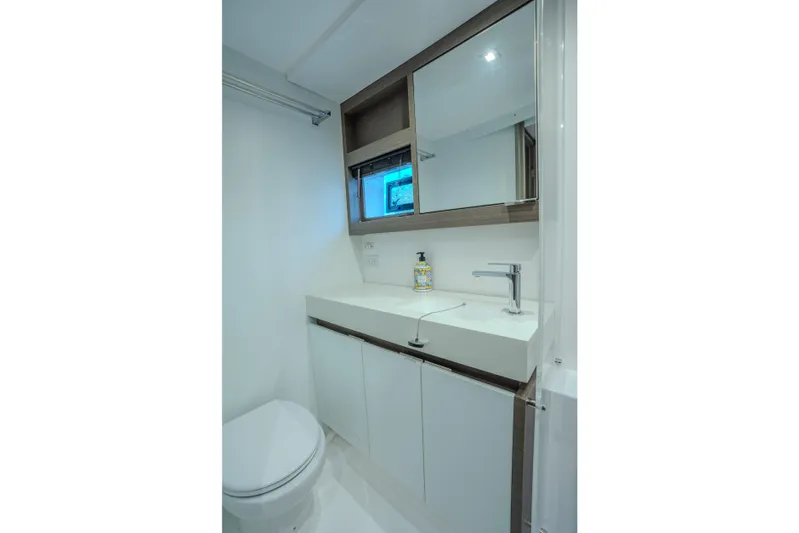 Althea Yacht Photos Pics Modern bathroom in 2025 Leopard 53 Powercat yacht, featuring sleek sink and cabinetry.