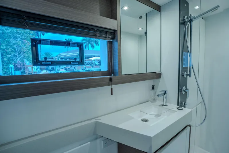 Althea Yacht Photos Pics Modern bathroom interior of 2025 Leopard 53 Powercat yacht with sleek design and window view.