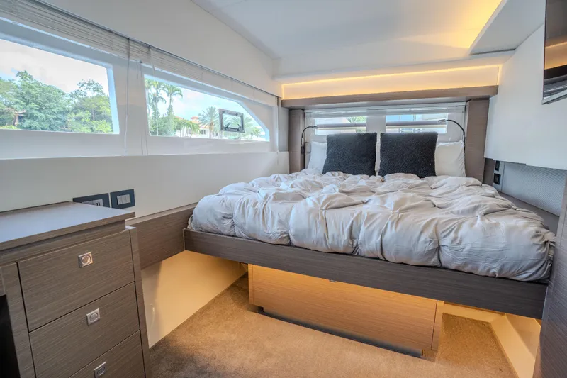 Althea Yacht Photos Pics Luxurious bedroom interior of 2025 Leopard 53 Powercat yacht with modern design and cozy bedding.