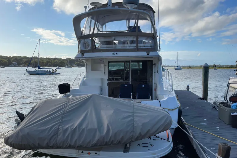  Yacht Photos Pics 2000 Sea Ray 400 Sedan Bridge yacht docked at marina, covered boat on deck.