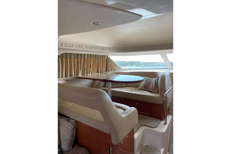  Yacht Photos Pics Interior of 2000 Sea Ray 400 Sedan Bridge with cozy seating and table.