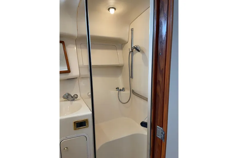  Yacht Photos Pics Bathroom interior of 2000 Sea Ray 400 Sedan Bridge yacht, featuring shower and sink.