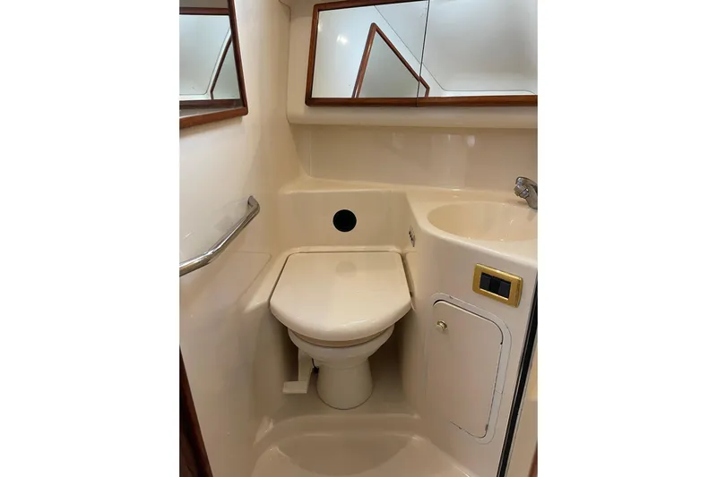  Yacht Photos Pics Bathroom interior of 2000 Sea Ray 400 Sedan Bridge yacht, featuring toilet and sink.