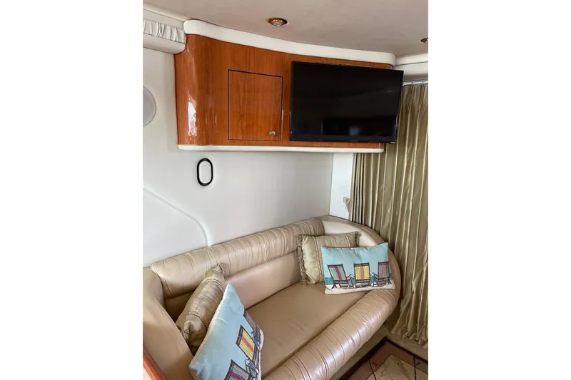  Yacht Photos Pics Luxurious interior of 2000 Sea Ray 400 Sedan Bridge with TV and plush seating.