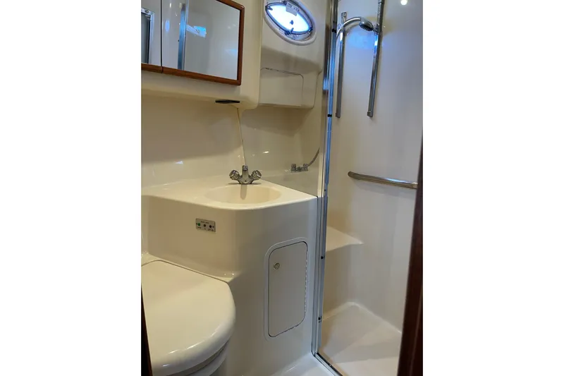  Yacht Photos Pics Bathroom interior of 2000 Sea Ray 400 Sedan Bridge yacht, featuring sink and shower.