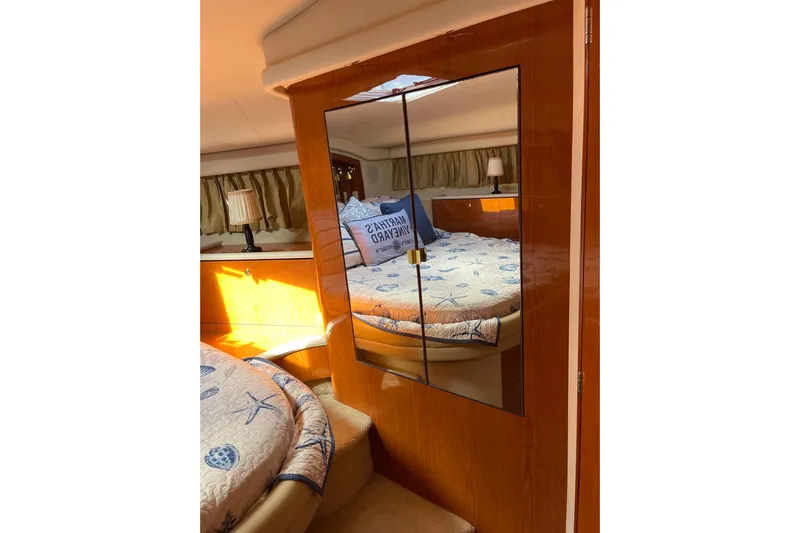  Yacht Photos Pics Interior of 2000 Sea Ray 400 Sedan Bridge with cozy bedroom and mirrored closet.