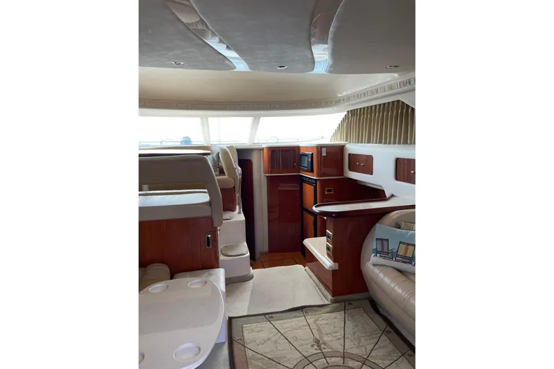  Yacht Photos Pics Interior of 2000 Sea Ray 400 Sedan Bridge yacht with elegant wood finishes.
