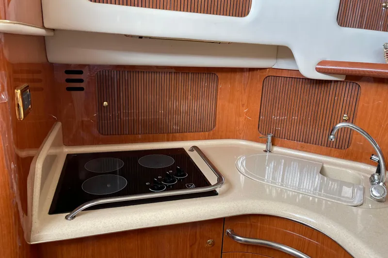  Yacht Photos Pics Kitchen area of 2000 Sea Ray 400 Sedan Bridge with stove and sink.
