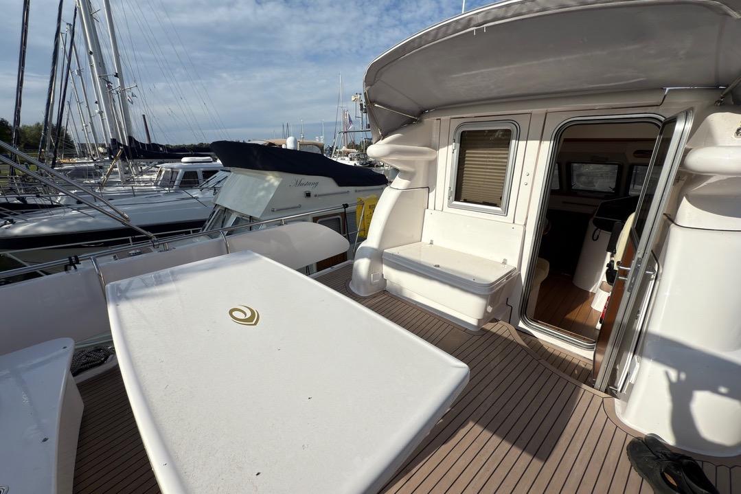 2023 Elling E4 yacht deck with open cabin door, docked at marina.