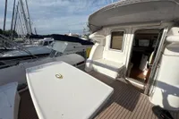 2023 Elling E4 yacht deck with open cabin door, docked at marina.
