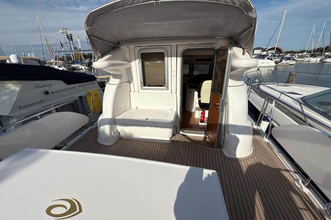 2023 Elling E4 yacht deck with open cabin door, docked at marina.
