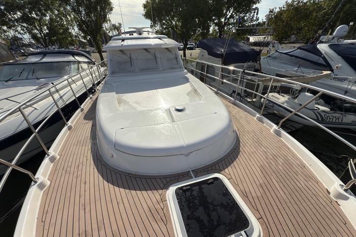 2023 Elling E4 yacht with sleek deck design, docked among other boats.