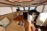 Luxurious interior of 2023 Elling E4 yacht with plush seating and elegant helm.