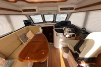 Luxurious interior of 2023 Elling E4 yacht with plush seating and modern helm.