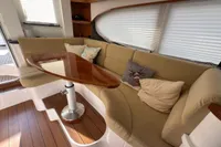Luxurious interior of 2023 Elling E4 yacht with plush seating and elegant wooden table.