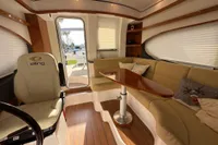 Luxurious 2023 Elling E4 yacht interior with plush seating and elegant wooden table.