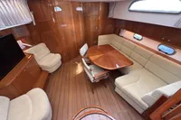 Luxurious interior of 2023 Elling E4 yacht with elegant wood finishes and plush seating.