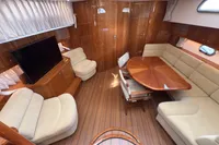 Luxurious interior of 2023 Elling E4 yacht with elegant wood finishes and comfortable seating.