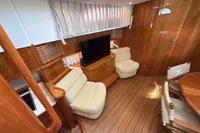 Luxurious 2023 Elling E4 yacht interior with wooden finish, plush seating, and a flat-screen TV.