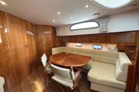 Luxurious interior of 2023 Elling E4 yacht with wooden finishes and plush seating.