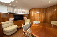 Luxurious interior of 2023 Elling E4 yacht with wooden finishes and comfortable seating.