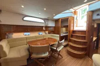 Luxurious interior of 2023 Elling E4 yacht with elegant wood finishes and cozy seating area.