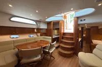 Luxurious interior of 2023 Elling E4 yacht with elegant wood finishes and comfortable seating.