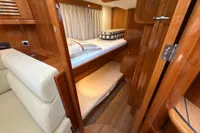 2023 Elling E4 yacht interior with wooden finish and cozy sleeping area.