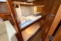 2023 Elling E4 yacht cabin with wooden interior and bunk beds.