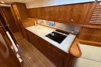 Luxurious 2023 Elling E4 yacht kitchen with sleek wood cabinetry and modern appliances.