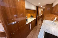 Luxurious 2023 Elling E4 yacht interior with elegant wood finishes and modern kitchen amenities.