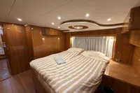Luxurious 2023 Elling E4 yacht cabin with elegant wood finish and cozy bedding.
