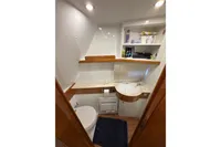 2023 Elling E4 yacht bathroom with modern fixtures, wooden accents, and ample storage space.