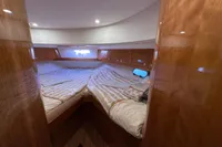 Luxurious cabin interior of 2023 Elling E4 yacht with cozy bedding and wooden finishes.
