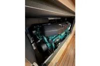 2023 Elling E4 engine compartment with visible components and wooden flooring.
