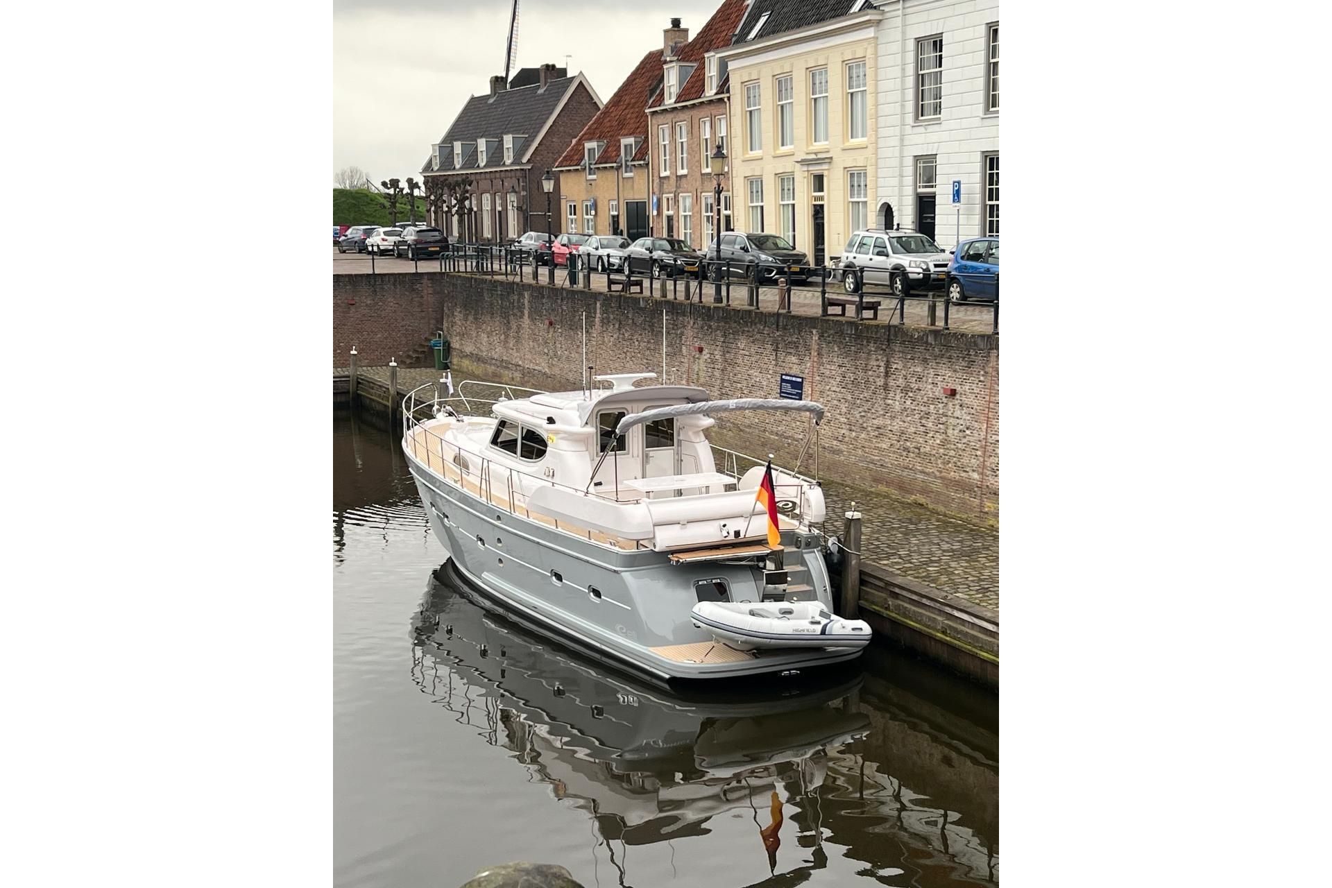 2023 Elling E4 yacht docked in a picturesque canal setting.