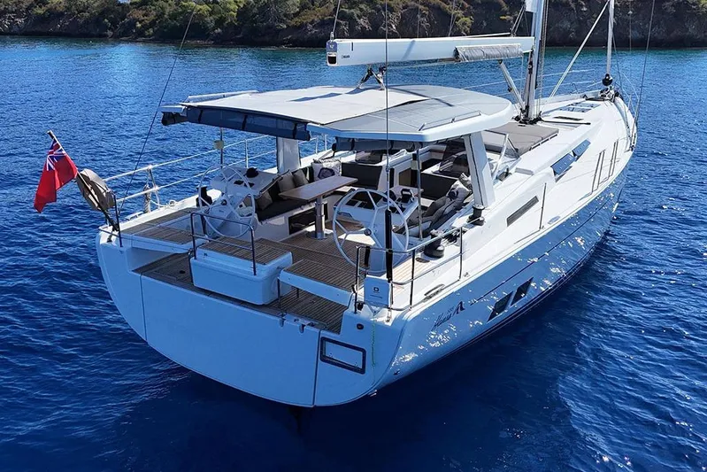 Nil Yacht Photos Pics 2024 Hanse 588 yacht sailing in clear blue waters, featuring a spacious deck.