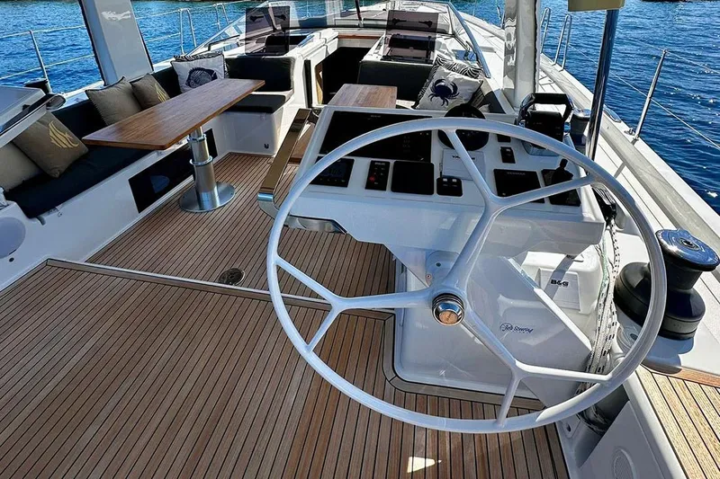 Nil Yacht Photos Pics Luxurious 2024 Hanse 588 yacht cockpit with modern steering wheel and elegant seating.