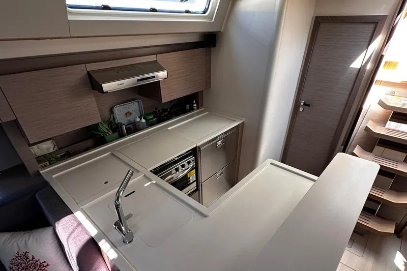 Nil Yacht Photos Pics Modern kitchen interior of 2024 Hanse 588 yacht, featuring sleek cabinetry and appliances.