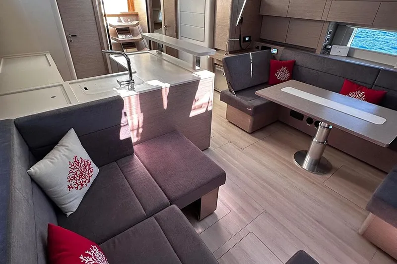 Nil Yacht Photos Pics Luxurious interior of 2024 Hanse 588 yacht with modern seating and dining area.