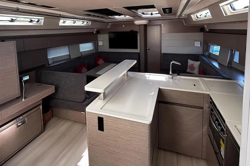 Nil Yacht Photos Pics 2024 Hanse 588 yacht interior with modern kitchen and cozy seating area.