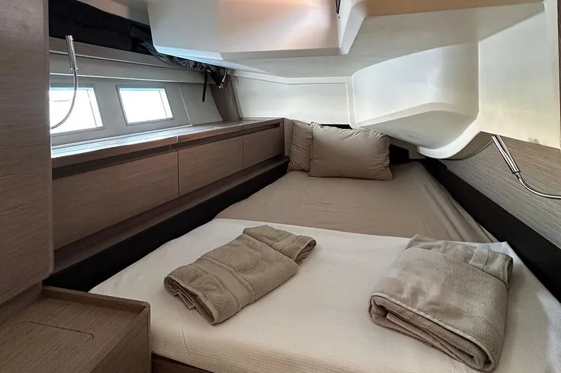 Nil Yacht Photos Pics Luxurious cabin interior of 2024 Hanse 588 yacht with cozy bedding and modern design.