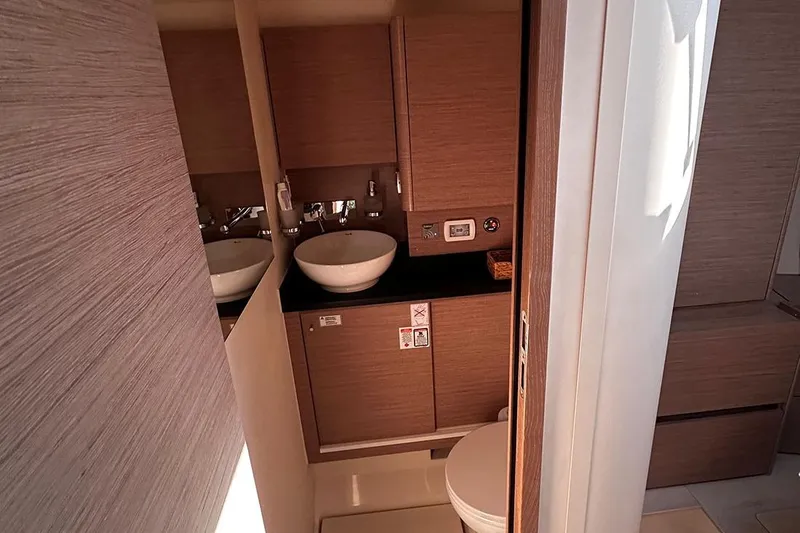 Nil Yacht Photos Pics 2024 Hanse 588 yacht bathroom with modern sink and wooden cabinetry.