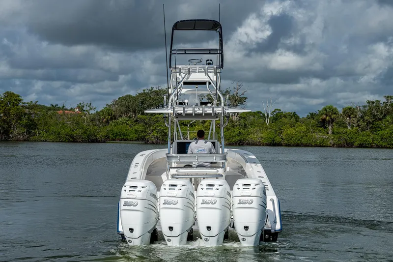  Yacht Photos Pics 2005 Venture 39 Open boat with quad engines on the water.