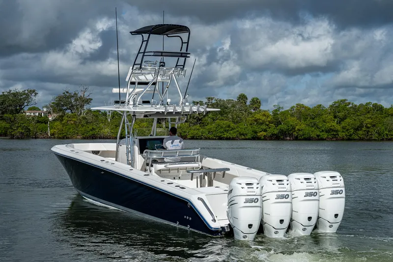  Yacht Photos Pics 2005 Venture 39 Open boat with quad 350 horsepower engines on a calm waterway.