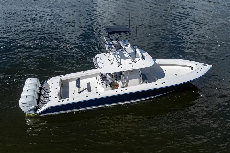  Yacht Photos Pics 2005 Venture 39 Open boat with triple outboard engines on the water.