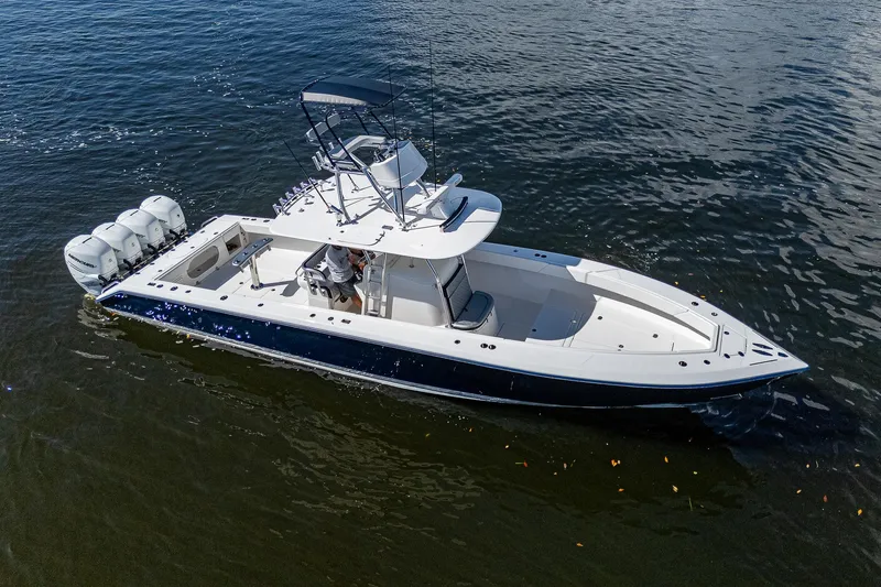  Yacht Photos Pics 2005 Venture 39 Open boat on water with triple outboard engines.